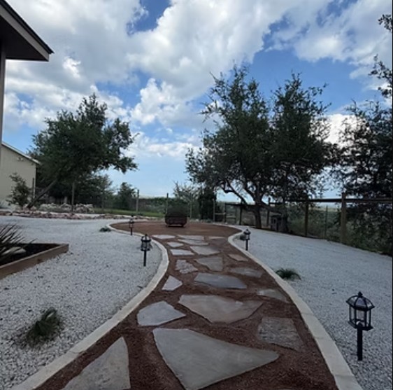 Flagstone pathway through decomposed granite with lantern lighting