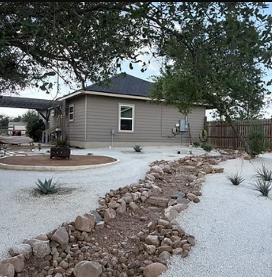 Xeriscape landscape with dry creek bed of native stone